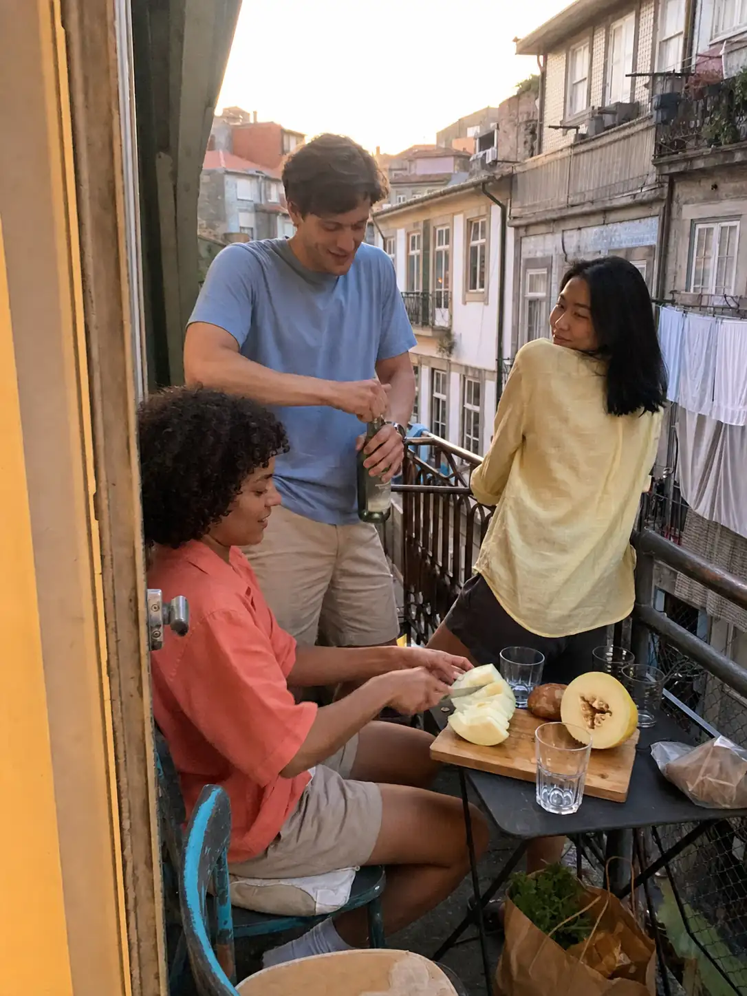 Friends spending their first evening on the apartment balcony